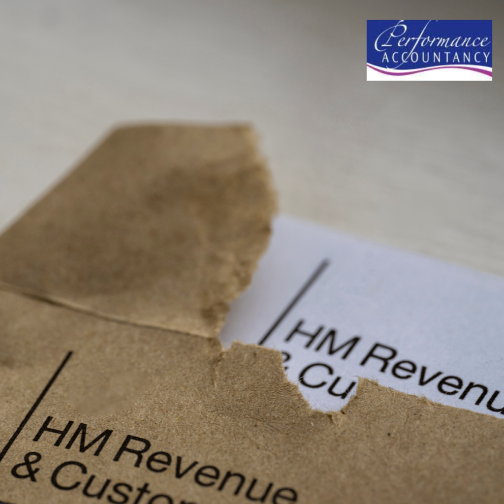 Close-up of a brown HM Revenue & Customs envelope being opened, revealing a document from HMRC